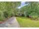 Elegant two-story home with a long driveway, mature trees, and meticulously manicured landscaping at 392 Tombee Ct, Mount Pleasant, SC 29464