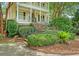 Attractive landscaping frames this Southern home with double porches and brick stairs to the front door at 392 Tombee Ct, Mount Pleasant, SC 29464