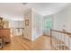 Bright hallway with hardwood floors, white trim, and a charming staircase at 392 Tombee Ct, Mount Pleasant, SC 29464
