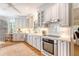 Bright white kitchen featuring modern appliances and marble backsplash at 392 Tombee Ct, Mount Pleasant, SC 29464