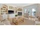 Cozy living room featuring built-in shelving, fireplace and french doors at 392 Tombee Ct, Mount Pleasant, SC 29464