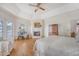 Cozy main bedroom showcasing a fireplace, wood floors, and balcony access with scenic views at 392 Tombee Ct, Mount Pleasant, SC 29464