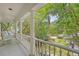 Spacious porch with rocking chairs and views of the landscaped front yard at 392 Tombee Ct, Mount Pleasant, SC 29464