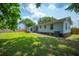 Well-maintained home exterior with a green lawn and access to the backyard at 401 Amy Dr, Goose Creek, SC 29445