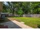 Large backyard with a concrete patio and mature trees, perfect for outdoor activities at 401 Amy Dr, Goose Creek, SC 29445
