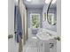 Charming bathroom with pedestal sink and classic black and white tiled floor at 401 Amy Dr, Goose Creek, SC 29445
