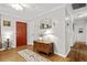 Bright entryway featuring hardwood floors, a red front door, and classic decorative accents at 401 Amy Dr, Goose Creek, SC 29445