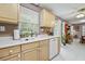 Functional kitchen featuring light wood cabinets, white countertops, and views to the backyard at 401 Amy Dr, Goose Creek, SC 29445