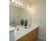 Bathroom features a double vanity with a large mirror, excellent lighting, and wood-finished cabinetry at 401 S Elgin Ct # 401, Charleston, SC 29414