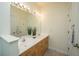Bathroom features a double vanity with a large mirror, excellent lighting, and wood-finished cabinetry at 401 S Elgin Ct # 401, Charleston, SC 29414
