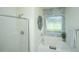 Bright bathroom with large tub, separate shower, decorative tile, and natural light from the window at 401 S Elgin Ct # 401, Charleston, SC 29414