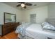 Comfortable bedroom with hardwood floors, ceiling fan, and a large dresser with mirror at 401 S Elgin Ct # 401, Charleston, SC 29414