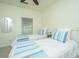 Charming bedroom featuring two twin beds with white bedding, ceiling fan and natural light at 401 S Elgin Ct # 401, Charleston, SC 29414