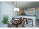 Cozy dining area with a dark wood table, stylish chairs, modern lighting, and a mirror on the wall at 401 S Elgin Ct # 401, Charleston, SC 29414