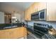 Close-up of kitchen featuring stainless steel appliances, light wood cabinets, and granite countertops at 401 S Elgin Ct # 401, Charleston, SC 29414