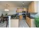 Bright kitchen features a granite breakfast bar, stainless steel appliances, and modern cabinetry at 401 S Elgin Ct # 401, Charleston, SC 29414