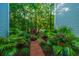 Beautifully landscaped path with brick pavers leading through lush greenery and flowering plants at 401 S Elgin Ct # 401, Charleston, SC 29414
