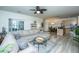 Open-concept living space with an oversized sectional sofa, adjacent dining area, and bright kitchen at 401 S Elgin Ct # 401, Charleston, SC 29414