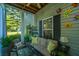 Relaxing screened porch with comfortable seating, decorative pillows, and a ceiling fan at 401 S Elgin Ct # 401, Charleston, SC 29414