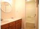Bathroom with double sink vanity, round mirror, and tub/shower with tile surround at 403 Sunny Side Way, Summerville, SC 29485
