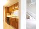 Kitchen with oak cabinets, a stainless-steel sink, and a view of the staircase at 403 Sunny Side Way, Summerville, SC 29485
