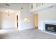 Bright and airy living room featuring a fireplace, neutral carpet, and stairway to the second floor at 403 Sunny Side Way, Summerville, SC 29485