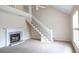 Spacious living room featuring a cozy fireplace and staircase leading to the second floor at 403 Sunny Side Way, Summerville, SC 29485