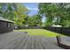 Spacious backyard featuring a wooden deck and outdoor seating, perfect for relaxation and entertainment at 403 Wedgewood St, Charleston, SC 29407