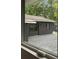 Home's backyard view from the window, complete with a spacious deck and lush green lawn at 403 Wedgewood St, Charleston, SC 29407