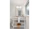 Well-lit vanity with marble countertop, decorative mirror and storage shelves for a stylish bathroom at 403 Wedgewood St, Charleston, SC 29407