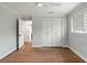 Light bedroom featuring hardwood floors, a ceiling fan and double closets with white doors at 403 Wedgewood St, Charleston, SC 29407