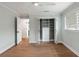 Bright bedroom with closet featuring built-in shelving, ceiling fan and hardwood floors at 403 Wedgewood St, Charleston, SC 29407