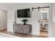 Bedroom with sliding barn door to en-suite bathroom, modern wooden cabinet at 403 Wedgewood St, Charleston, SC 29407