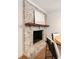 Fireplace with rustic wood mantle and brick facade at 403 Wedgewood St, Charleston, SC 29407