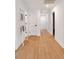 Well-lit hallway with beautiful hardwood floors, neutral paint, and a decorative ladder with throw blankets at 403 Wedgewood St, Charleston, SC 29407