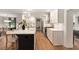 Bright kitchen featuring an island with a white countertop, black cabinets, and modern pendant lights at 403 Wedgewood St, Charleston, SC 29407