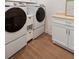 Bright laundry room with modern white appliances and butcher block countertop at 403 Wedgewood St, Charleston, SC 29407