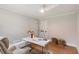 Inviting home office space with modern white desk, comfortable chair, and ample natural light from a nearby window at 403 Wedgewood St, Charleston, SC 29407