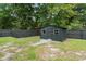 Backyard view featuring a storage shed with windows and a door, situated in a well-maintained yard at 403 Wedgewood St, Charleston, SC 29407