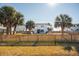 Well-maintained backyard with tall privacy fence, lush green grass and beautiful landscaping, perfect for entertaining at 405 Palmetto Blvd, Edisto Island, SC 29438