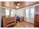 Cozy bedroom with natural wood ceiling, two twin beds, and plenty of natural light from the dual windows at 405 Palmetto Blvd, Edisto Island, SC 29438