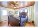 Comfortable bedroom features wood accents, ceiling fan, and is brightly lit with natural light at 405 Palmetto Blvd, Edisto Island, SC 29438