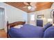Comfortable bedroom with wood accents and a ceiling fan and is brightly lit with natural light at 405 Palmetto Blvd, Edisto Island, SC 29438