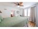 Bright bedroom features closet, bedding, window views and ceiling fan at 405 Palmetto Blvd, Edisto Island, SC 29438