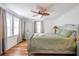 Bedroom with wood ceiling, closet, windows and bed with green bedding at 405 Palmetto Blvd, Edisto Island, SC 29438