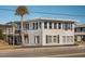 A two-story home, enhanced with black shutters and lush palm tree at 405 Palmetto Blvd, Edisto Island, SC 29438