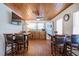 Kitchen with appliances, wooden cabinets, dining area, wood ceilings and flooring at 405 Palmetto Blvd, Edisto Island, SC 29438