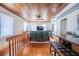 Cozy living area with comfortable seating, a TV, and a bar area, all under a wood-paneled ceiling at 405 Palmetto Blvd, Edisto Island, SC 29438