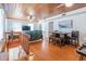Open concept living area with wood floors, ceiling fan, a staircase and seating with a TV at 405 Palmetto Blvd, Edisto Island, SC 29438