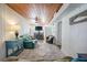 Bright living room offers seating, wood ceilings, ceiling fan, console table and views of fireplace at 405 Palmetto Blvd, Edisto Island, SC 29438